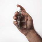 Hand holding the Überlube Signature Bottle