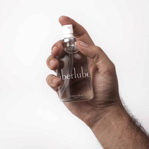 Hand holding the Überlube Signature Bottle