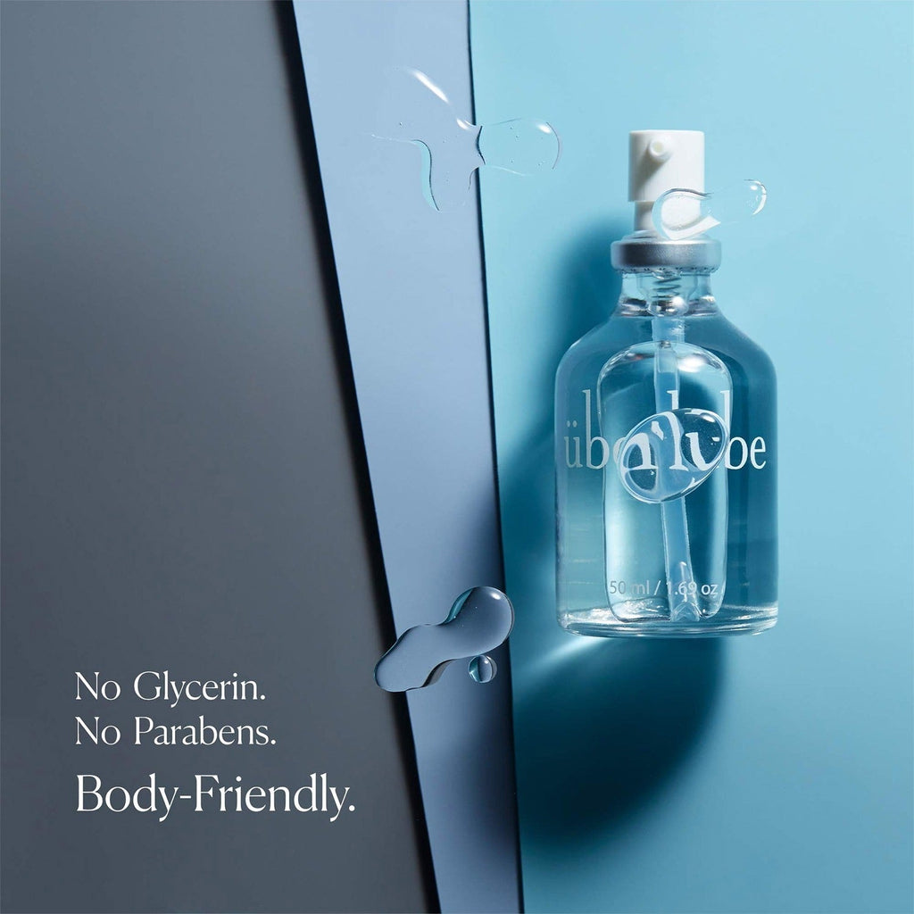 Überlube Signature Bottle with water droplets on a blue background