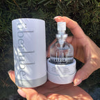 Holding the Überlube Signature Bottle and travel tube