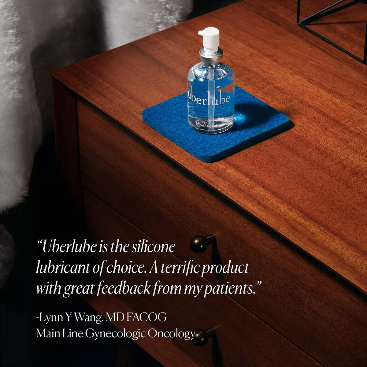 Überlube Signature Bottle on a wooden dresser